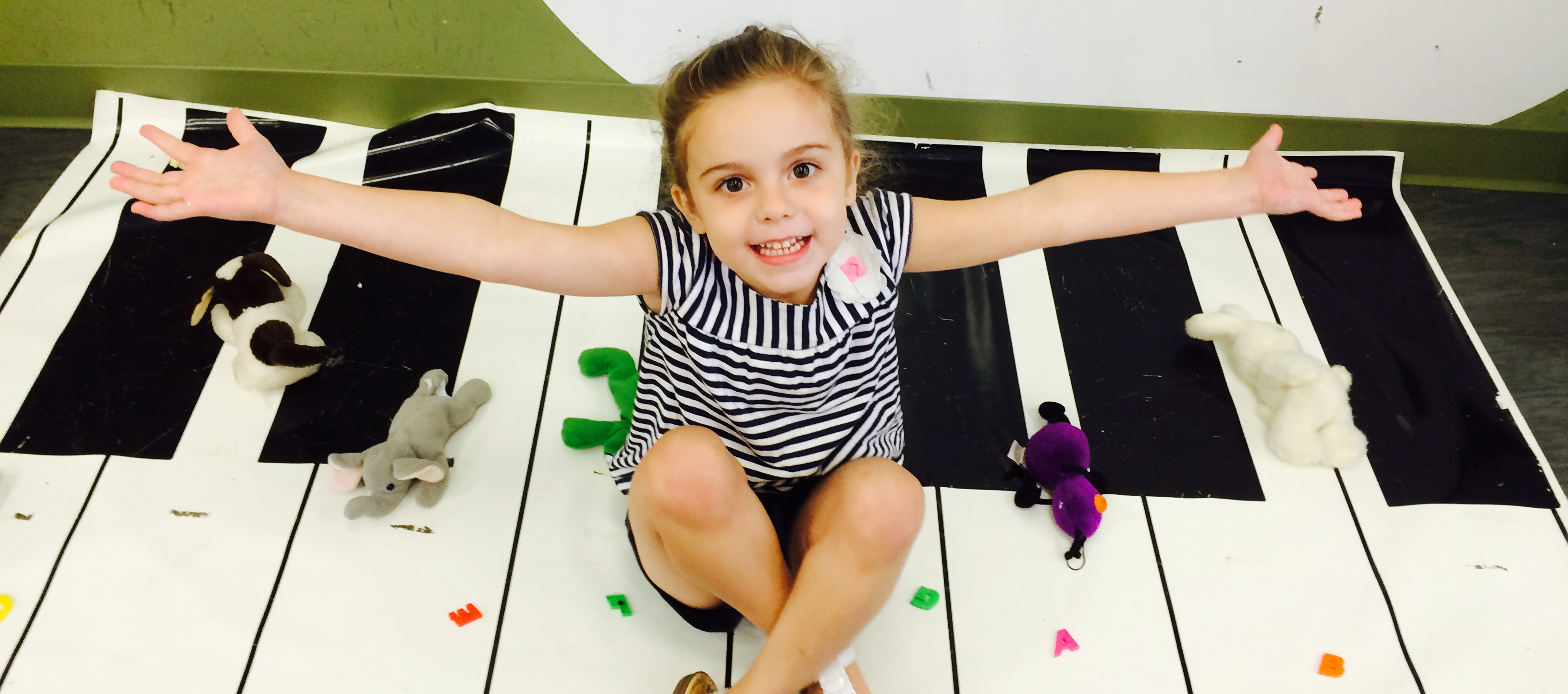 child sitting on a mat that looks like a piano