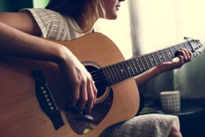 Girl playing an acoustic guitar