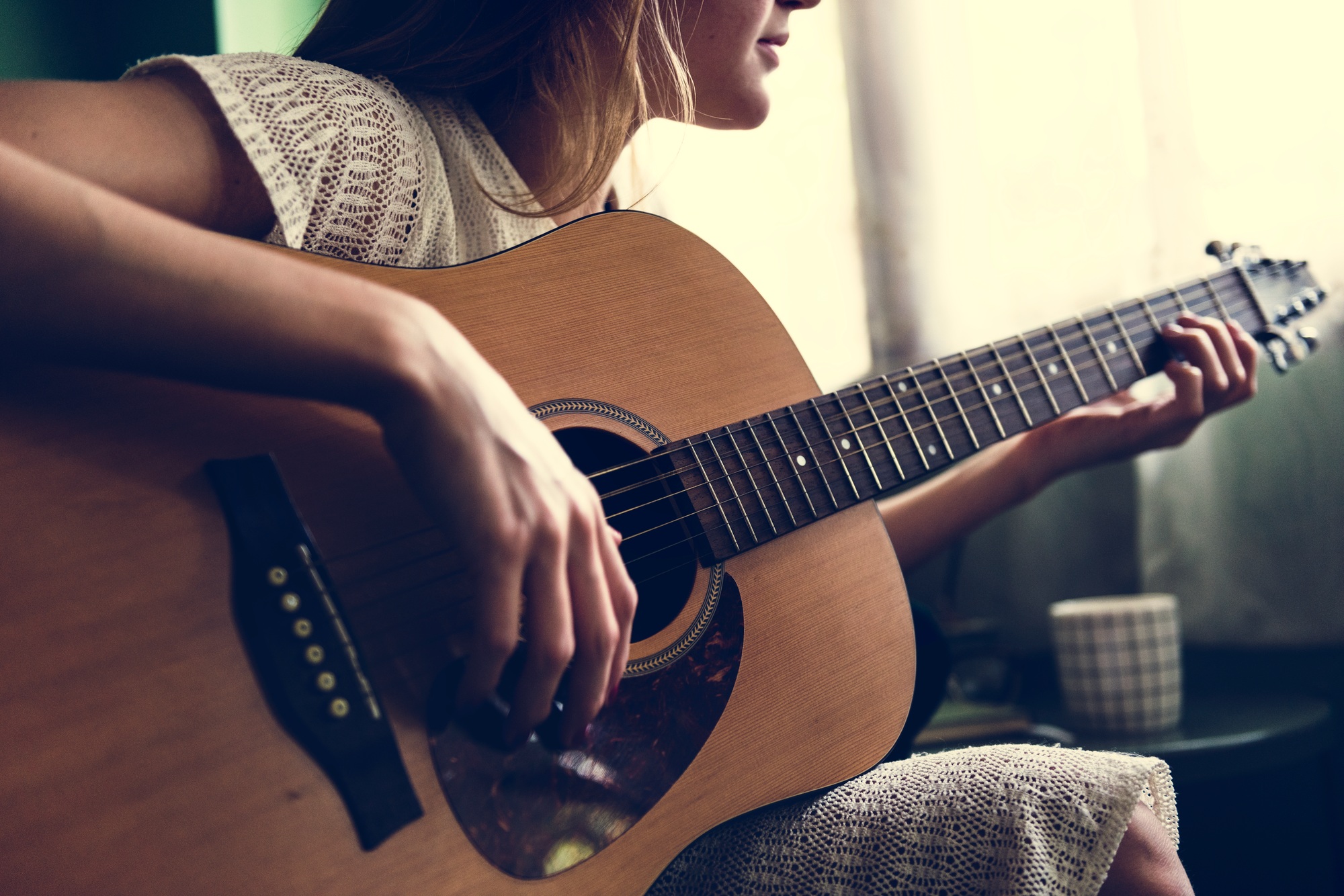 Girl playing an acoustic guitar