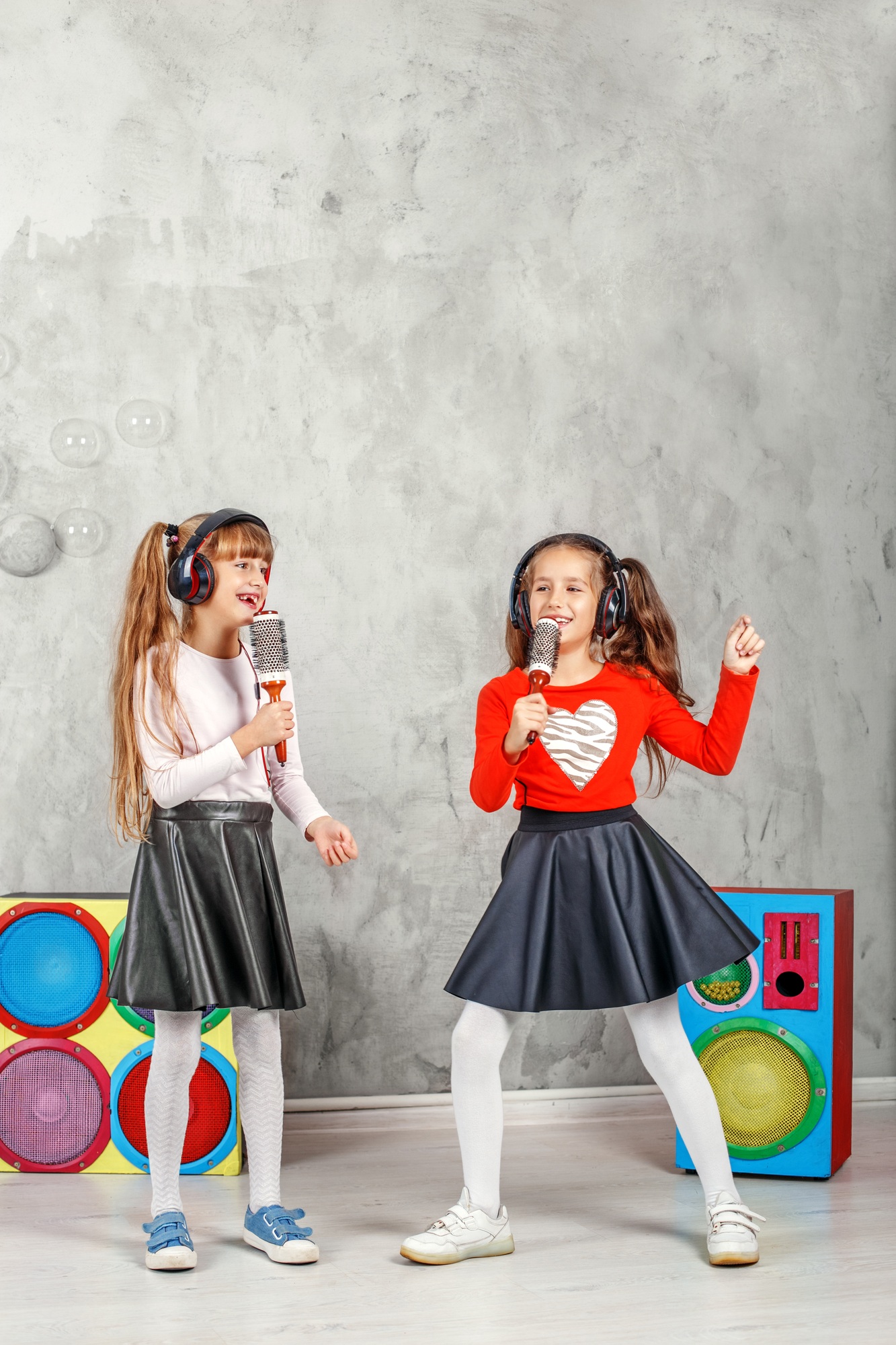 Happy children sing and listen to music in headphones. The conce