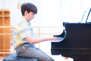 Student taking a private piano lesson