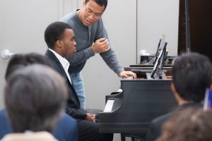Piano student getting instruction from Washington Conservatory instructor during an audience performance